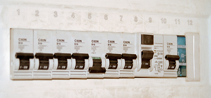 Water and electrical shut-off valves on a wall. 