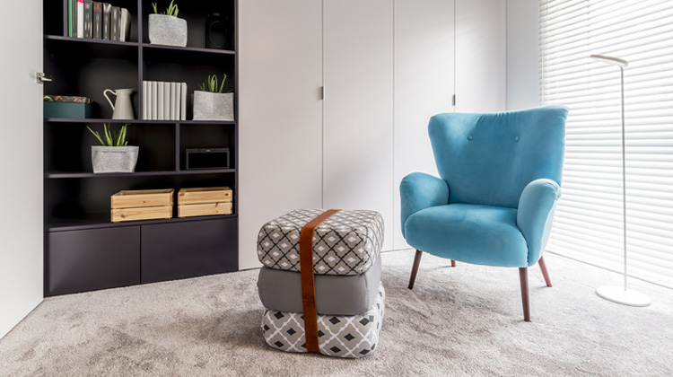 Sky blue chair and cushions in a white room