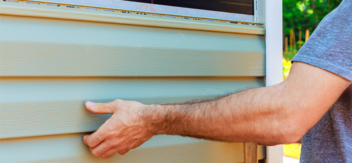 A person sliding out a panel from a home.