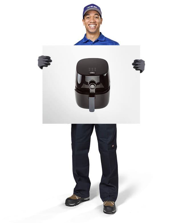1-800-GOT-JUNK? Truck Team Member holding an image of a air fryer