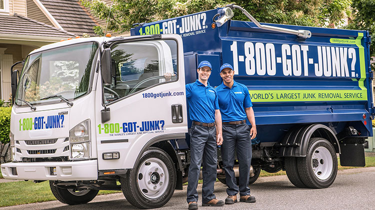 Two Truck Team Members standing in front of the 1-800-GOT-JUNK? truck