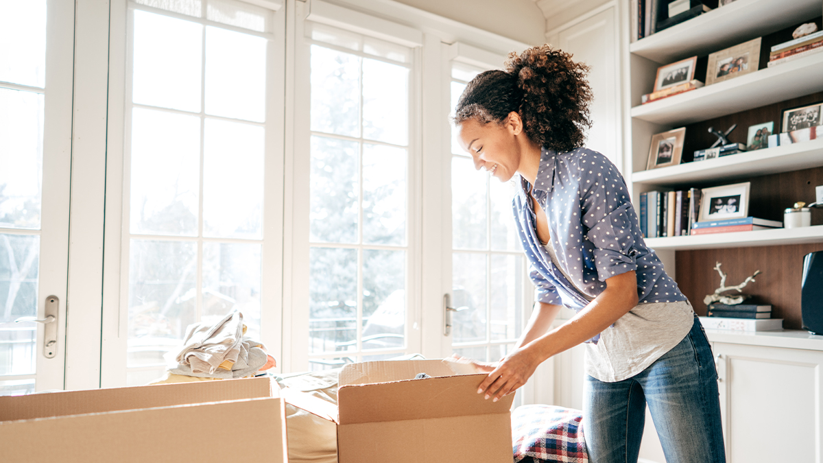 Woman packing up unwanted items for disposal